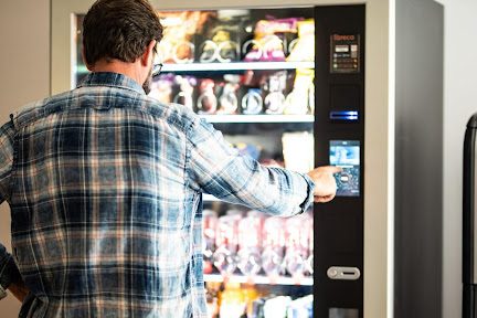 Man buying from vending machine.