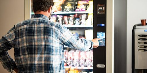 Man buying from vending machine.