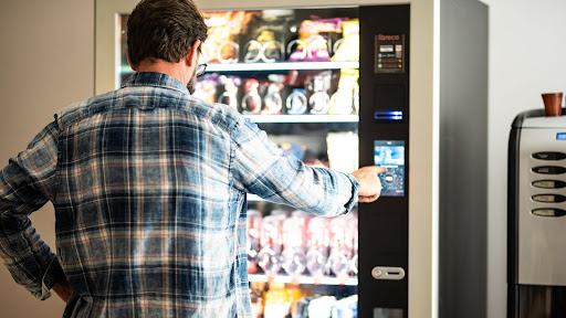 Man buying from vending machine.